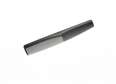 Comb made by plastic, wood or metal with a row of narrow teeth, used for arranging the hair.の写真素材