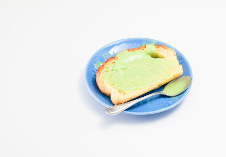 Bread coating with pandan custard on white table