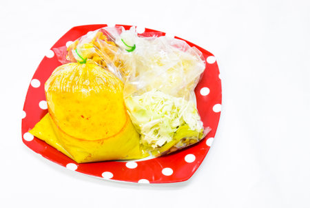 Fired noodle in chicken curry or Kao Soi Kai in thailand language package in plastic bag on the white table.の写真素材