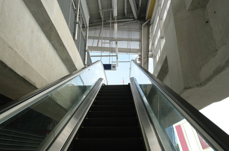 Escalator at skytrain station to the top platform for waiting trainの写真素材