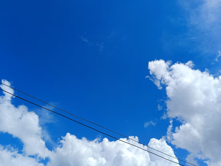 Azure sky and electric line on sunny day but sky have many cloud to warn that the rain will come to this area in few timeの写真素材