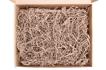 Opened recycled taped cardboard posting and shipping box with tissue krinkles filler. Isolated on...