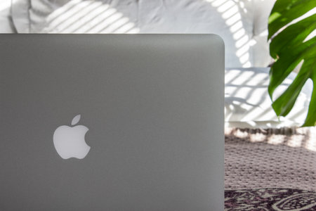 Moscow, Russia - 6 September 2018. Macbook Pro on a bed in sunny day. Mockup for the decals