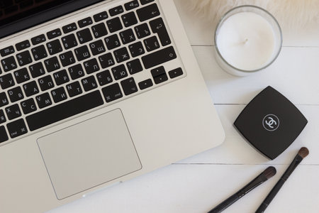 Moscow/Russia - April 28 2019: Apple Macbook Pro Retina on a desk, table with candle and make-up stuff. Mock-up for decal, sticker designのeditorial素材