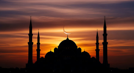 Silhouette of the mosque at sunset with the crescent moonの素材