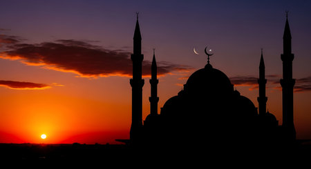 Silhouette of mosque at sunset. Ramadan Kareem background.の素材