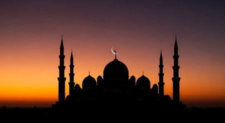 Silhouette of mosque at sunset, Ramadan Kareem background.の素材