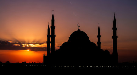 Silhouette of mosque at sunset. Ramadan Kareem background.の素材