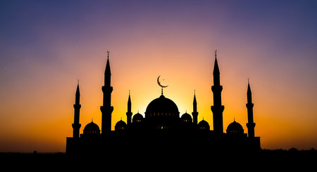 Silhouette of mosque at sunset, Ramadan Kareem background.の素材