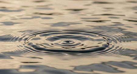 Water drop with ripples and ripples on the surface of the waterの素材