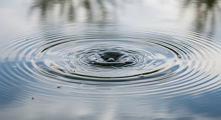 Water drop close up with ripples and ripples on water surfaceの素材
