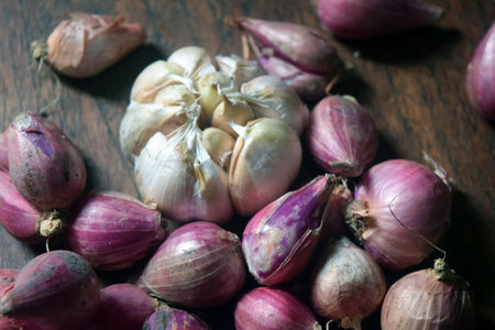 Garlic and shallot on wooden background. Selective focus.の写真素材