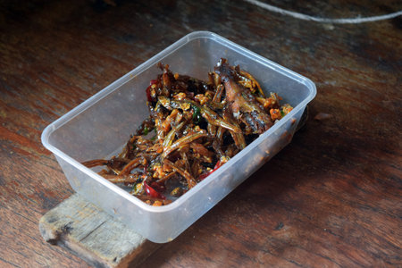 Fried anchovy with chili on wooden background,Thai foodの写真素材