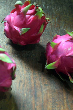 Dragon fruit on wooden table. Healthy food. Pitaya or pitahayaの写真素材