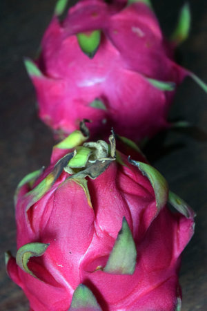 Dragon fruit on wooden table. Dragon fruit is a pitaya plant.の写真素材
