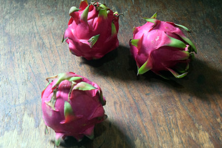 Dragon fruit on wooden table. Ripe pitahaya fruits.の写真素材