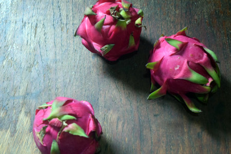 Dragon fruit on wooden table. Close up of pitahaya.の写真素材