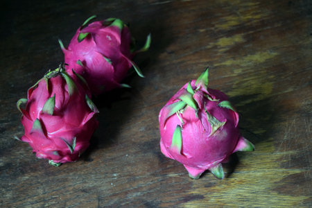 Dragon fruit on wooden background. Sweet and sour pitahaya.の写真素材
