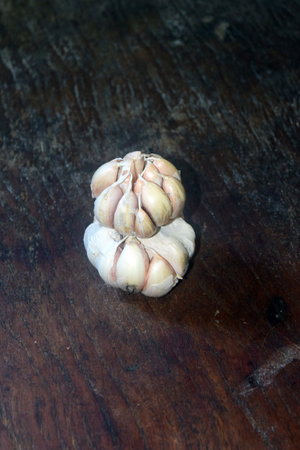 garlic on wood background, garlic is a genus of herbaceous plants in the family Ranunculaceaeの写真素材