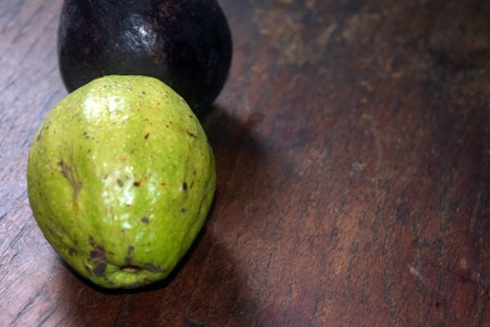 Avocado and guacamole on a wooden table. Tropical fruit.の写真素材