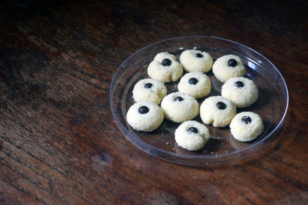 cookies with black olives in a glass plate on a wooden tableの写真素材