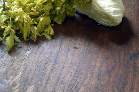 cabbage and celery on the wooden table in the kitchen.の写真素材