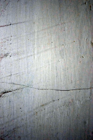 Cement wall with cracks and scratchesbe used as backgroundの写真素材