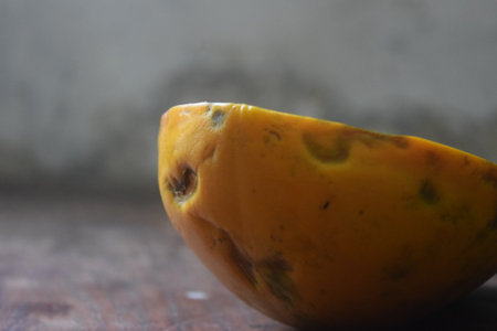 Papaya fruit on wooden table, close up, selective focus
