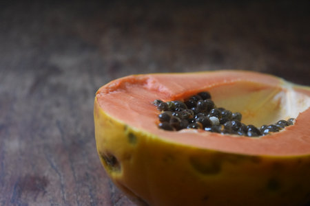Papaya fruit on wooden background, selective focus and shallow DOF.