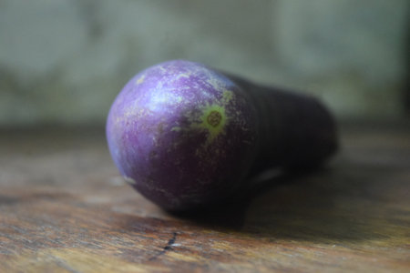 purple eggplant on old wooden table, selective focus on purple eggplantの写真素材