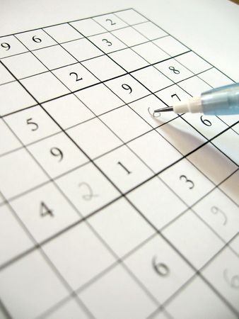 A partially filled sudoku puzzle with pencil.  Sudoku is an addictive Japanese math puzzle whose aim is to fill in a grid so that every row, every column, and every 3x3 box contains the numbers 1 to 9.の写真素材