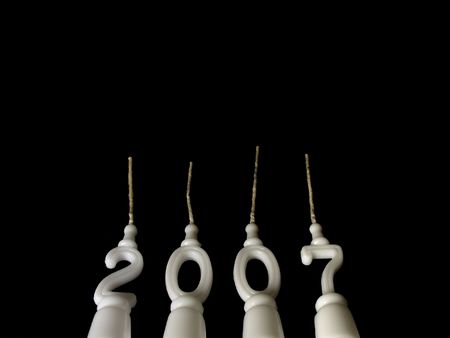 New Year celebration: candles showing year 2007 seen from below on black background, with copy space aboveの写真素材