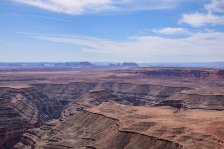 Stunning aerial view from Muley Point, Utah, showcasing the rugged landscape of the desert and the Valley of the Gods. The image captures the vast desert scenery under a clear blue sky - USAの写真素材