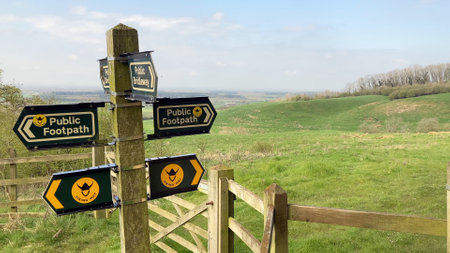 Signpost indicating directions for public footpaths and the Viking Way in a rural, scenic landscape - Lincolnshire, UKの写真素材