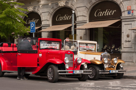 PRAGUE, CZECH REPUBLIC - APRIL 21, 2017: Two vintage Ford cars parked in front of a Cartier shop in the Parizska street, offering sightseeing tours for touristsのeditorial素材