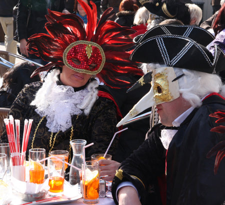 People in costumes and masks having drinks at the Venice carnival. Venice, Italy, 5th March 2011のeditorial素材