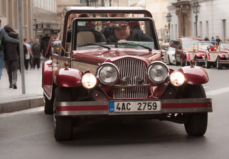 PRAGUE, CZECH REPUBLIC - APRIL 15, 2017: Historical car takes tourists for a tour in the city centerのeditorial素材