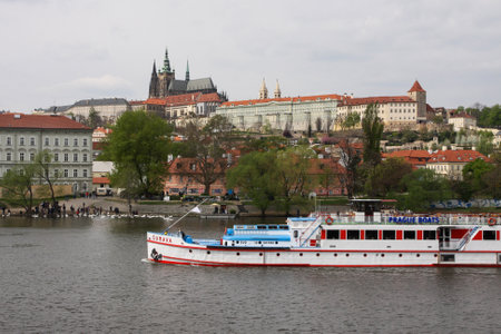 PRAGUE, CZECH REPUBLIC - APRIL 15, 2017: Sumava boat on the Vltava river, with the Prague Castle in the backgroundのeditorial素材