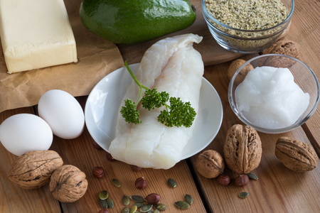 Healthy fats - wild caught fish, avocado, butter, eggs, hemp seeds, walnuts, hazelnuts, pumpkin seeds, coconut oilの写真素材
