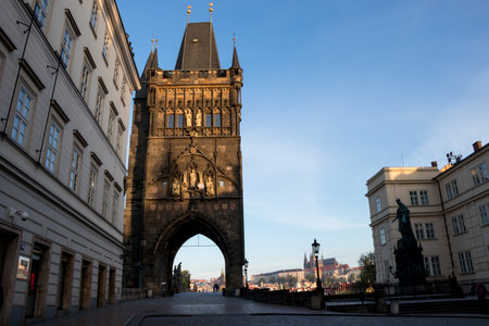 PRAGUE, CZECH REPUBLIC - MAY 10, 2017: The Old Town Bridge Tower, leading to the Charles Bridge, with Prague Castle in the background and the statue of King Charles IV in the foregroundのeditorial素材