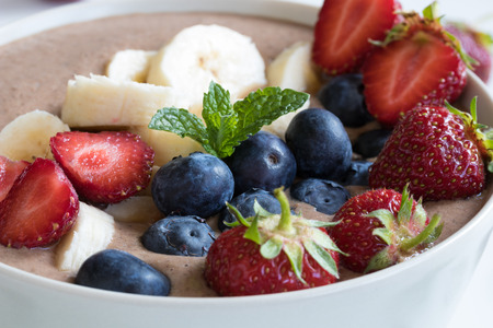 Summer breakfast: raw breakfast bowl with strawberries and blueberriesの写真素材