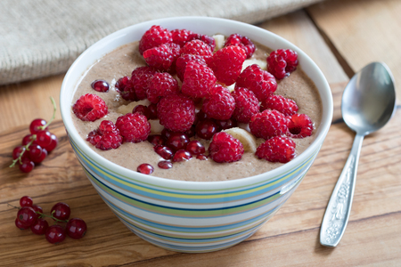 Summer breakfast - raw breakfast bowl with raspberries and red currantsの写真素材
