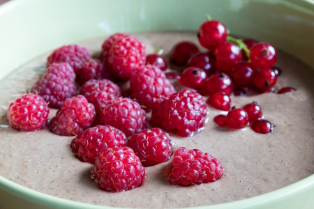 Summer breakfast - raw breakfast bowl with raspberries and red currantsの写真素材
