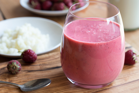 Milk kefir with strawberries on a wooden backgroundの写真素材