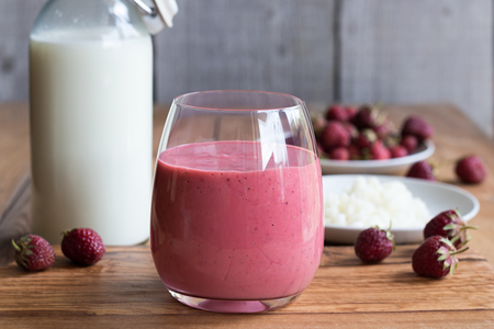 Milk kefir with strawberries on a wooden backgroundの写真素材