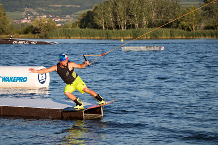 PASOHLAVKY, CZECH REPUBLIC - JUNE 26, 2017: Rider wakeboarding in the cable wake park Wake Merkur in South Moraviaのeditorial素材