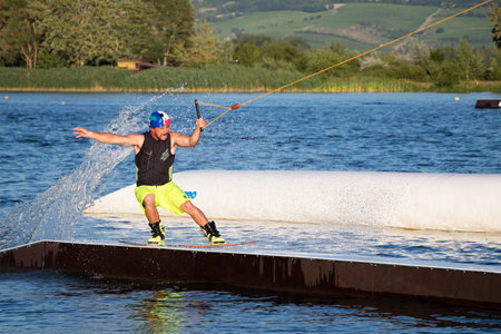 PASOHLAVKY, CZECH REPUBLIC - JUNE 26, 2017: Rider wakeboarding in the cable wake park Wake Merkur in South Moraviaのeditorial素材