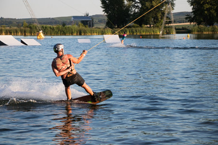 PASOHLAVKY, CZECH REPUBLIC - JUNE 26, 2017: Rider wakeboarding in the cable wake park Wake Merkur in South Moraviaのeditorial素材
