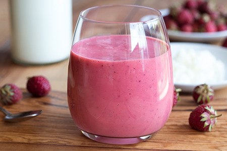 Milk kefir with strawberries on a wooden backgroundの写真素材