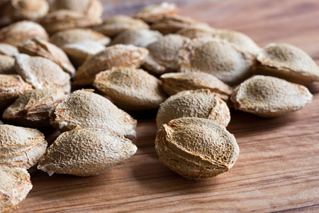 Apricot kernels on a wooden backgroundの写真素材